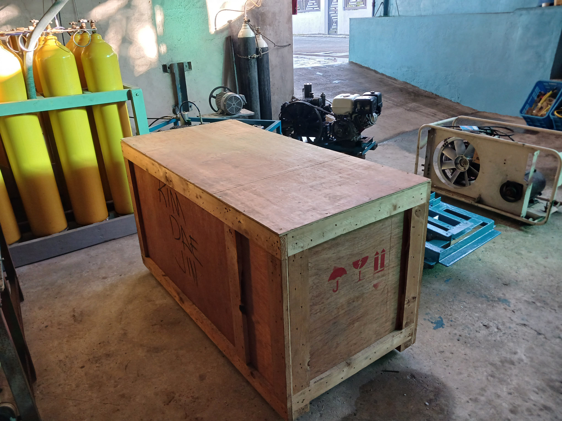 Incoming compressor shipment crate staged in the workshop