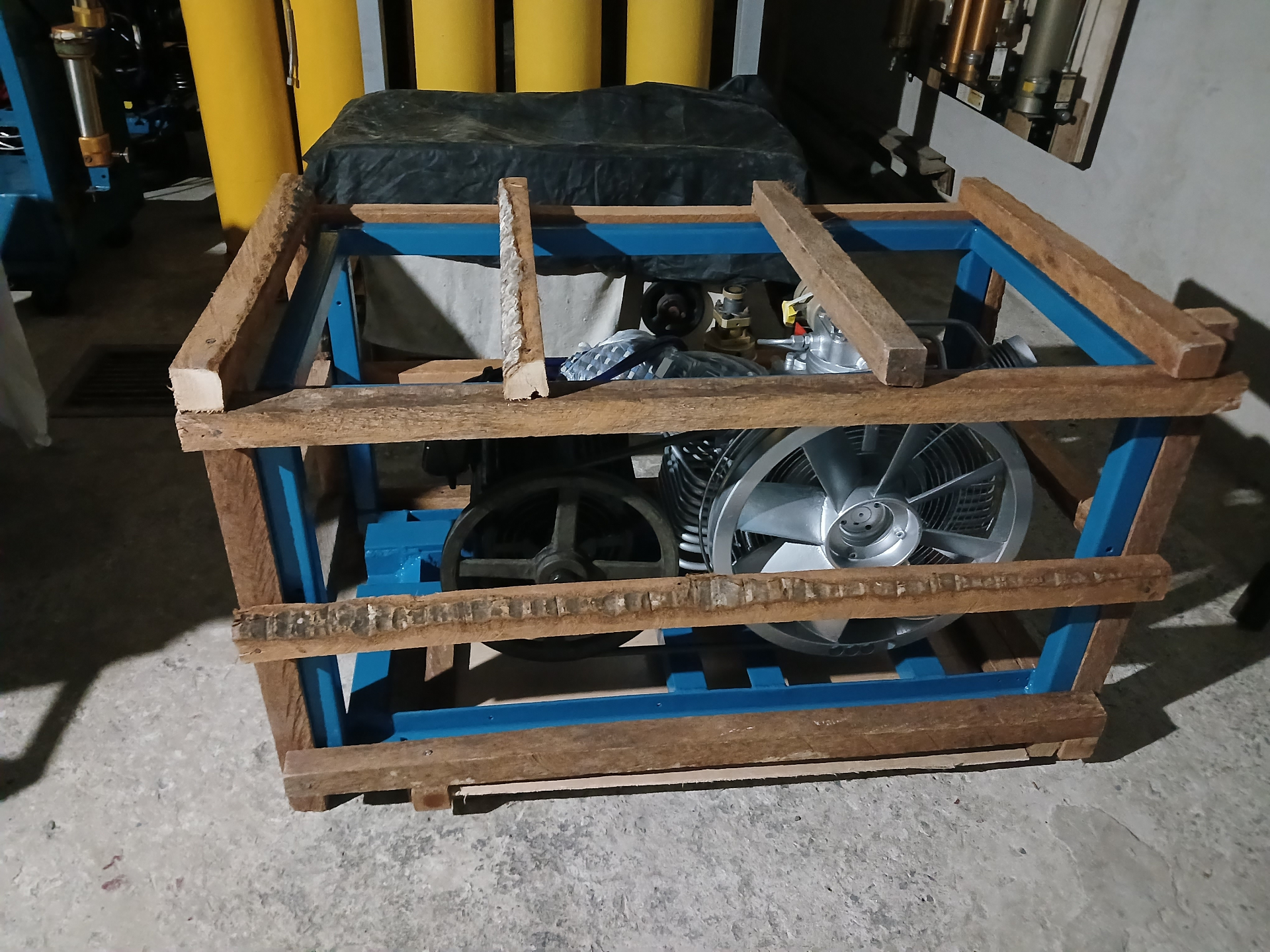 Freshly built blue-frame compressor secured for delivery