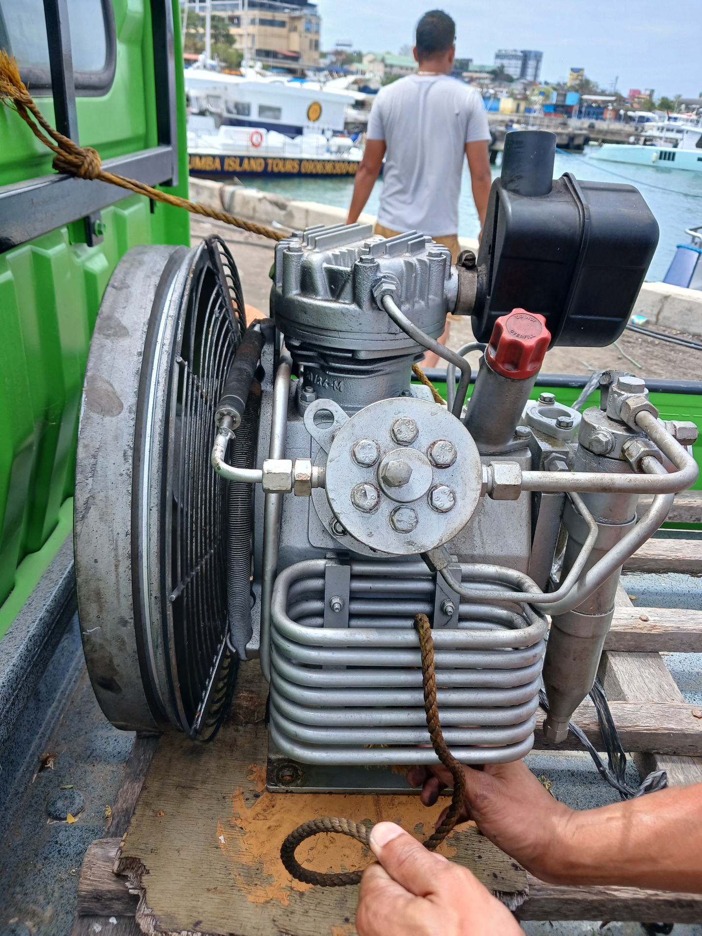 Portable compressor staged dockside before a charter