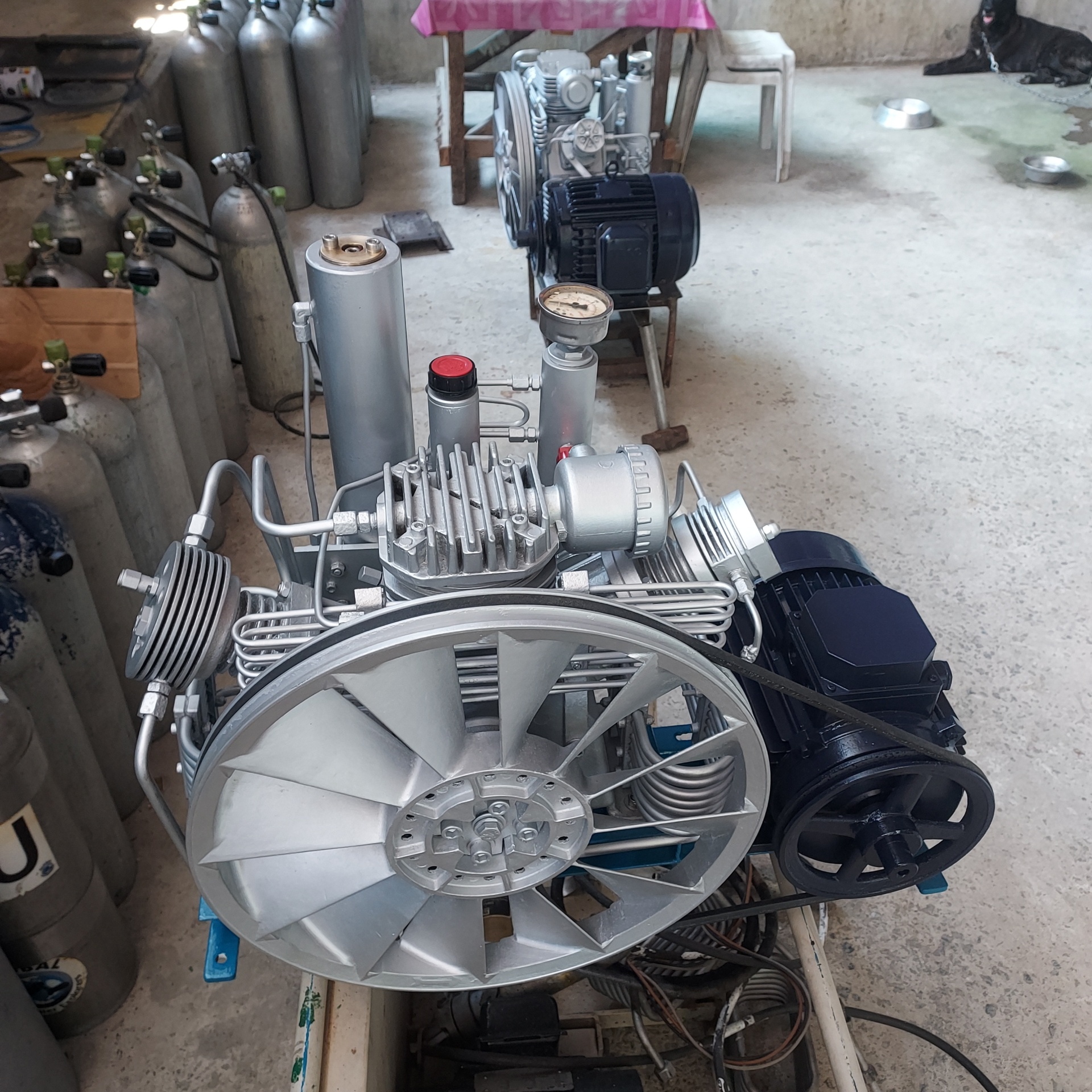 Freshly rebuilt compressor with flywheel assembly on the shop floor