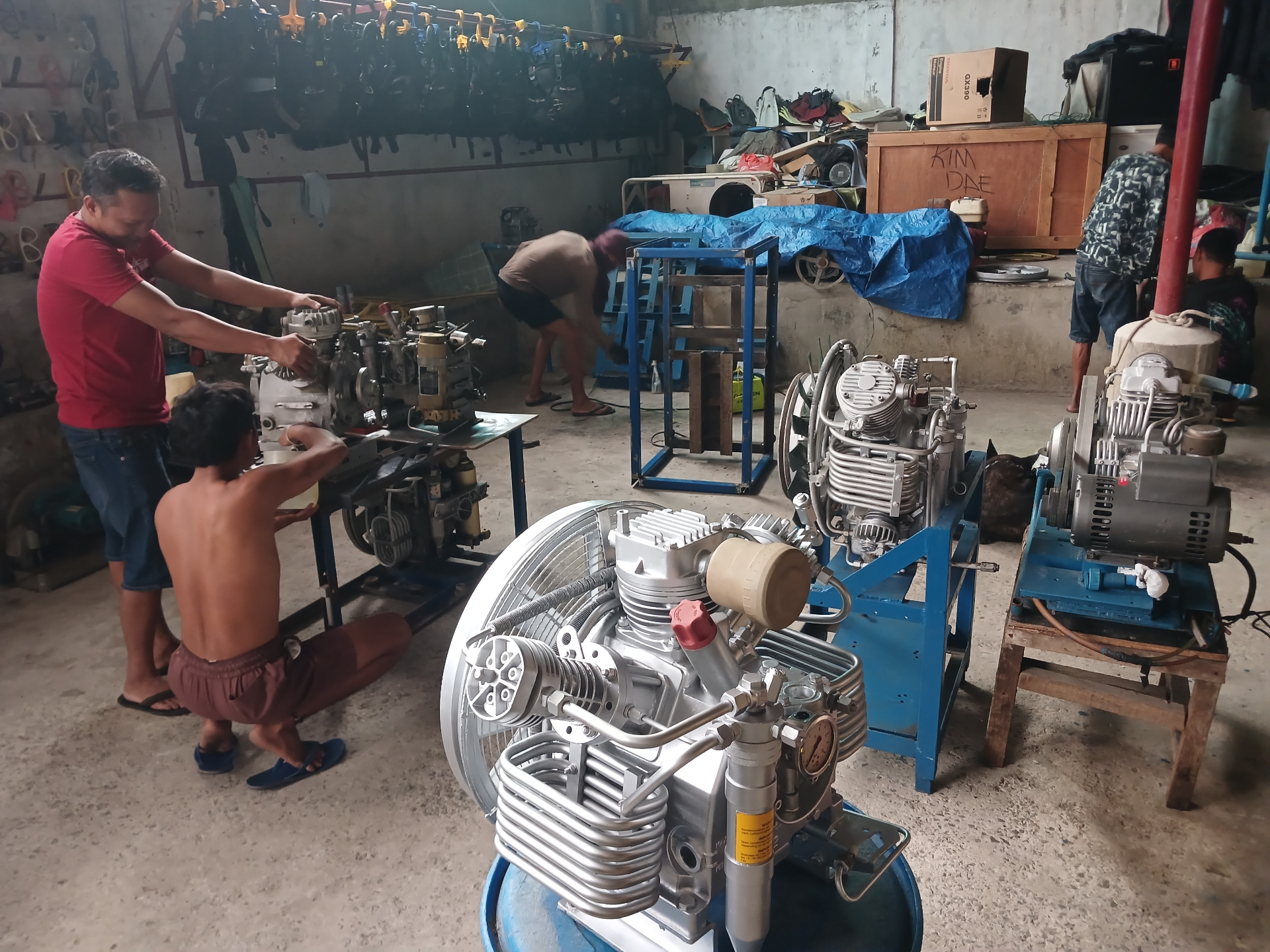 Three rebuilt compressors staged in the workshop during assembly
