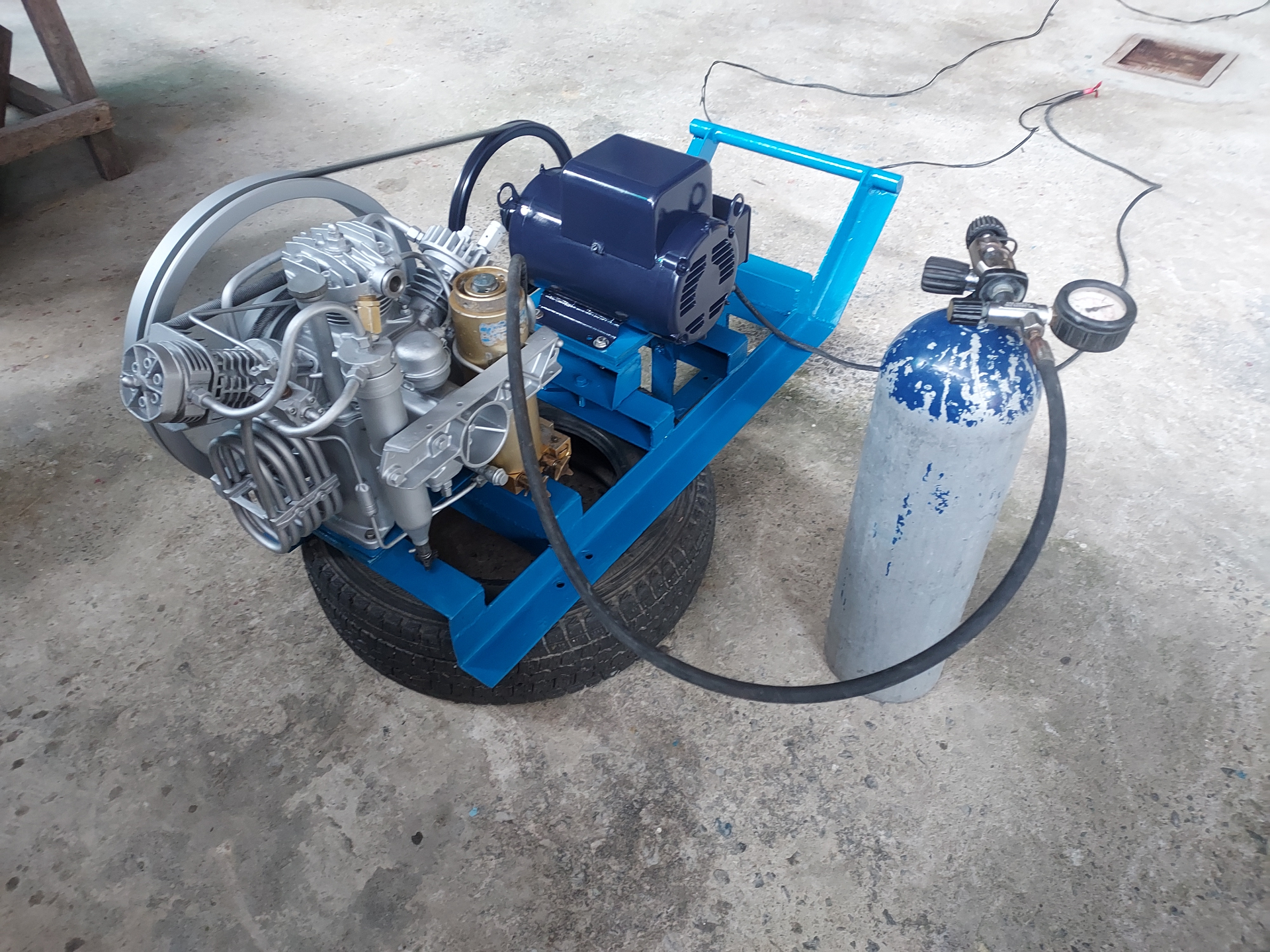 Freshly rebuilt portable compressor under fill test with cylinder