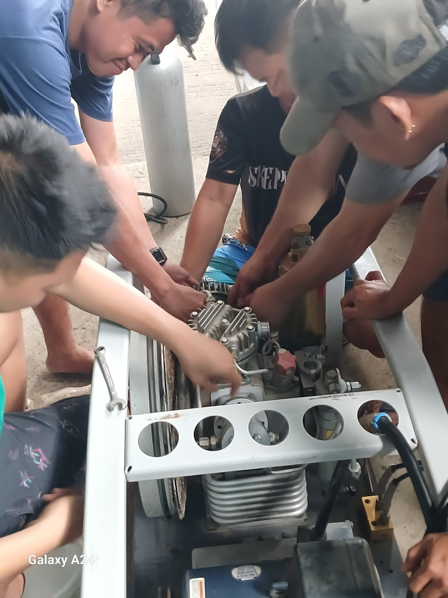 Close-up of the team working through a compressor rebuild