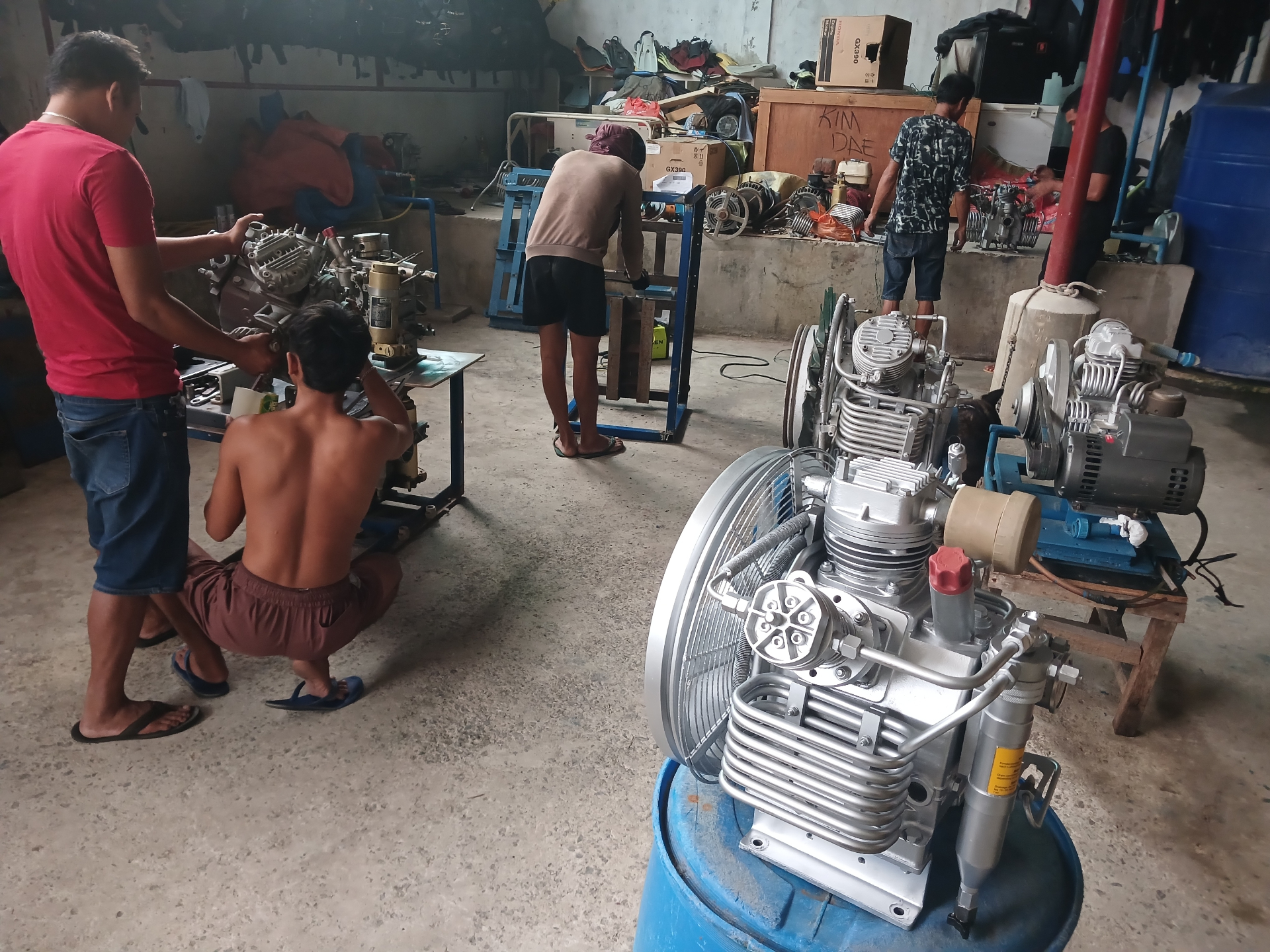 Workshop team rebuilding compressors across the service floor